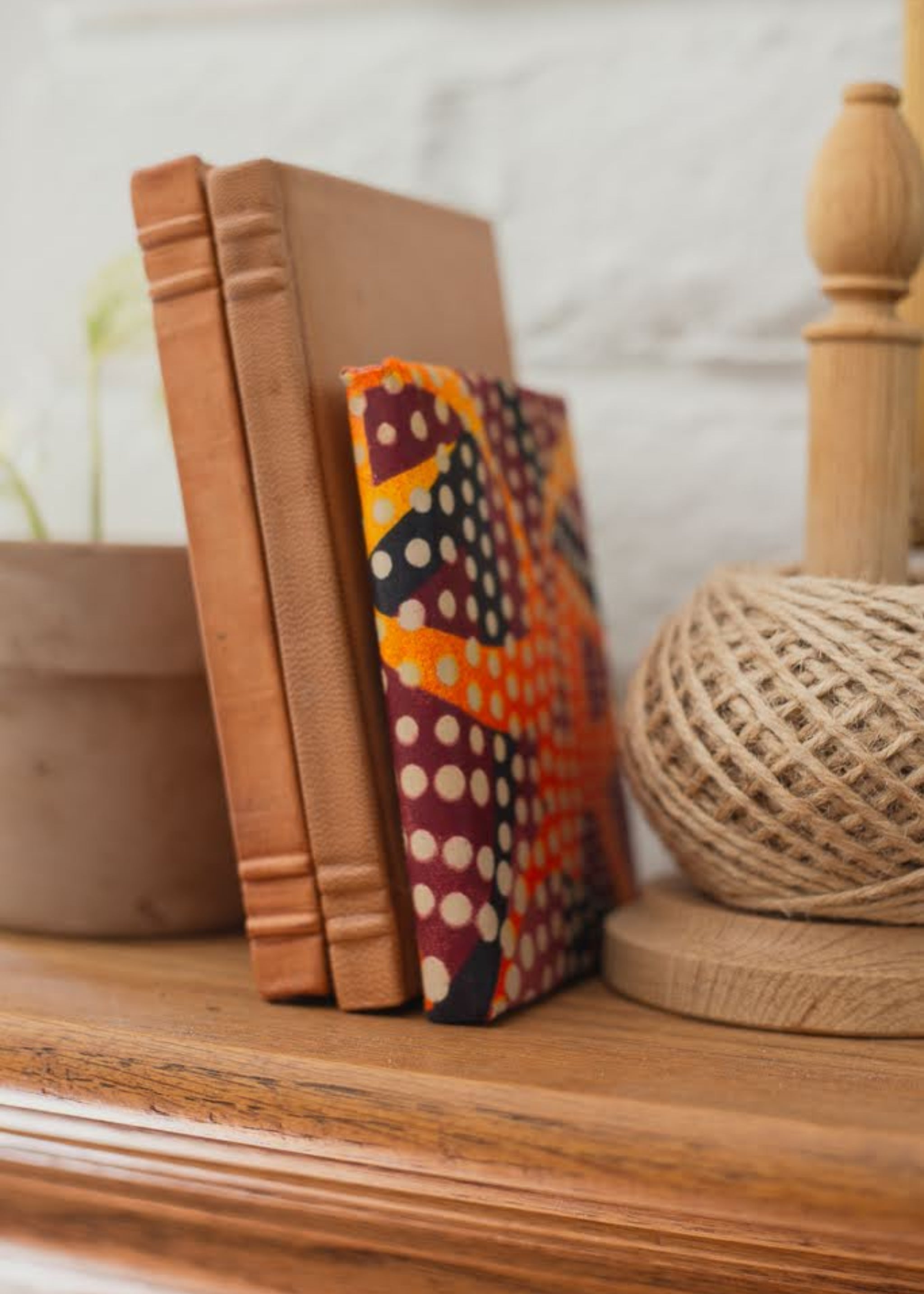 Colorful patterned journal on a wooden shelf