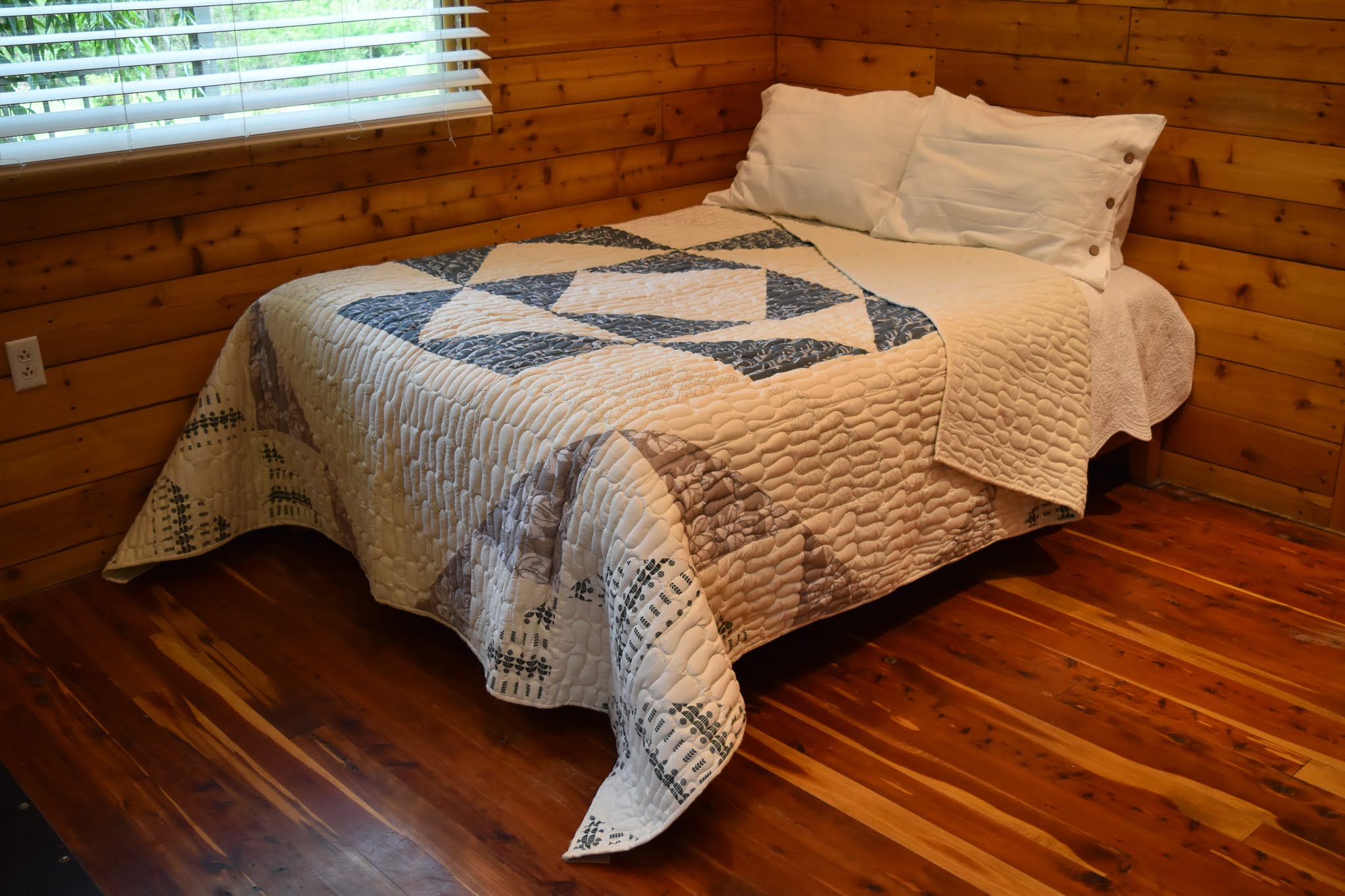 A handmade Kenyan quilt - cotton kitenge and batik cloth hand stitched together by the Amani women for a Fair Trade boutique