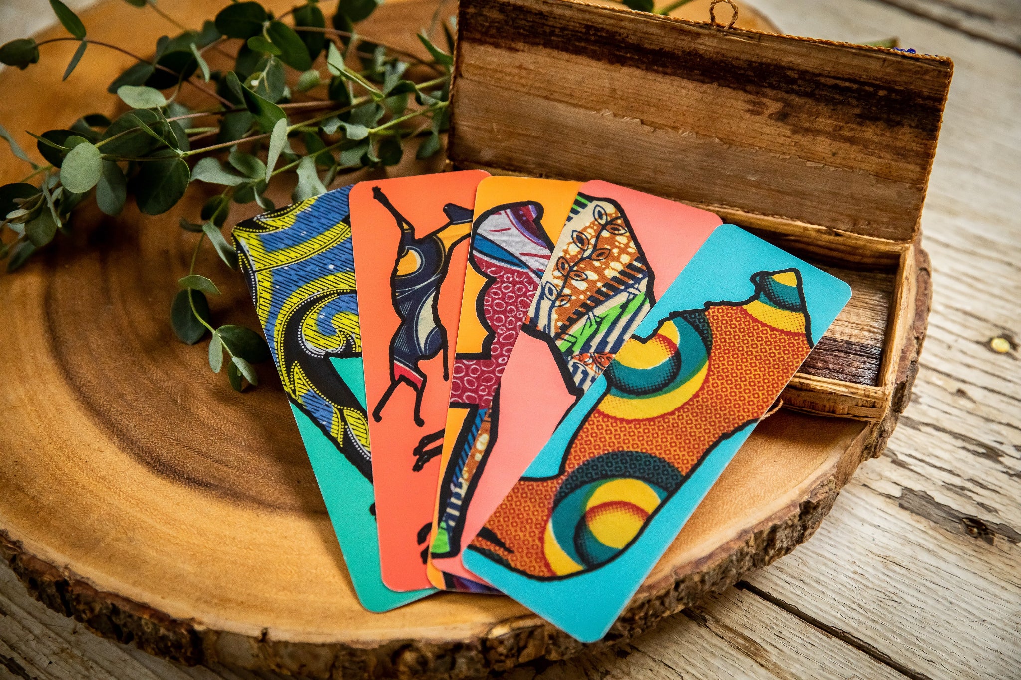 Five colorful safari animal bookmarks fanned out on a wooden background