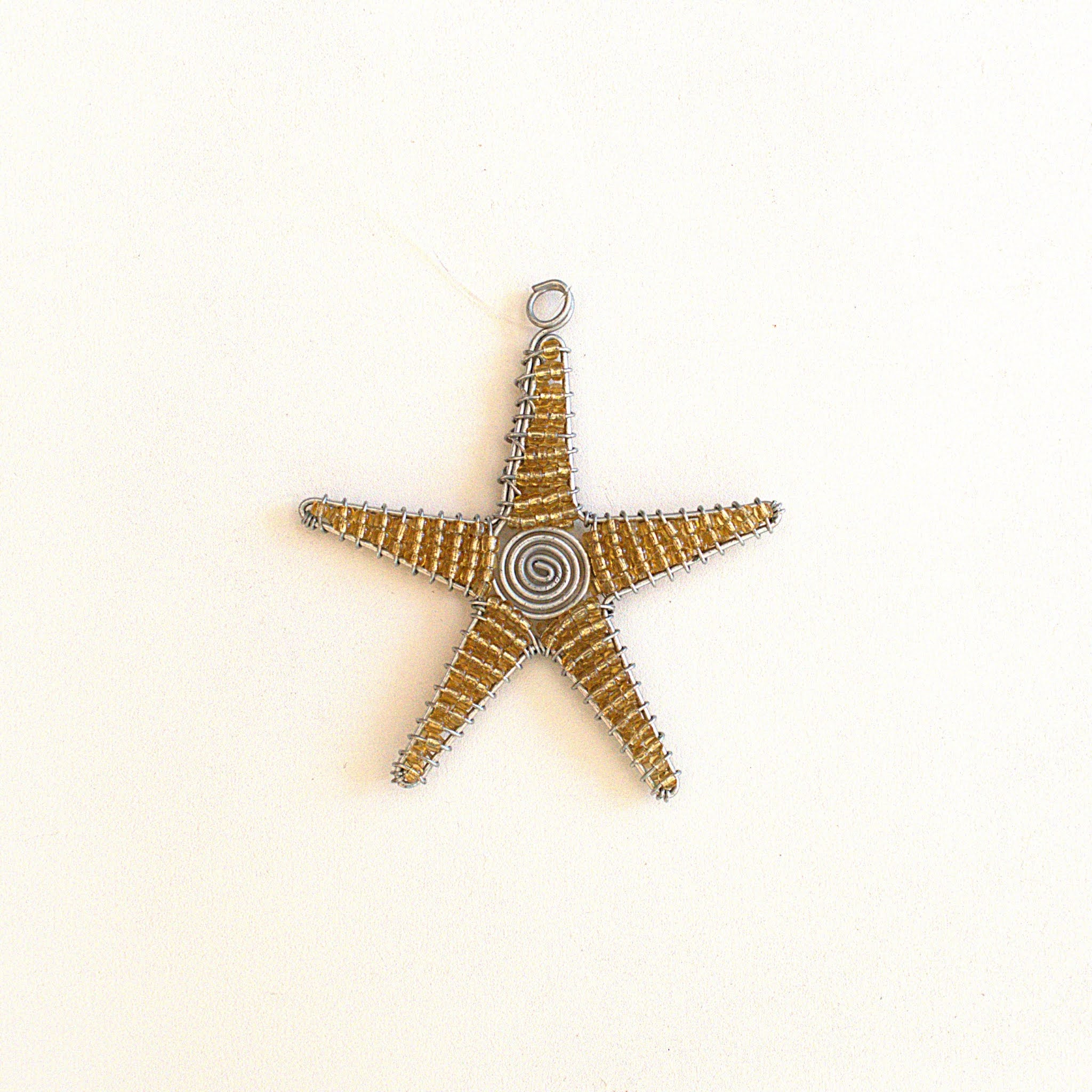 Star-shaped decorative item with a spiral center on a white background