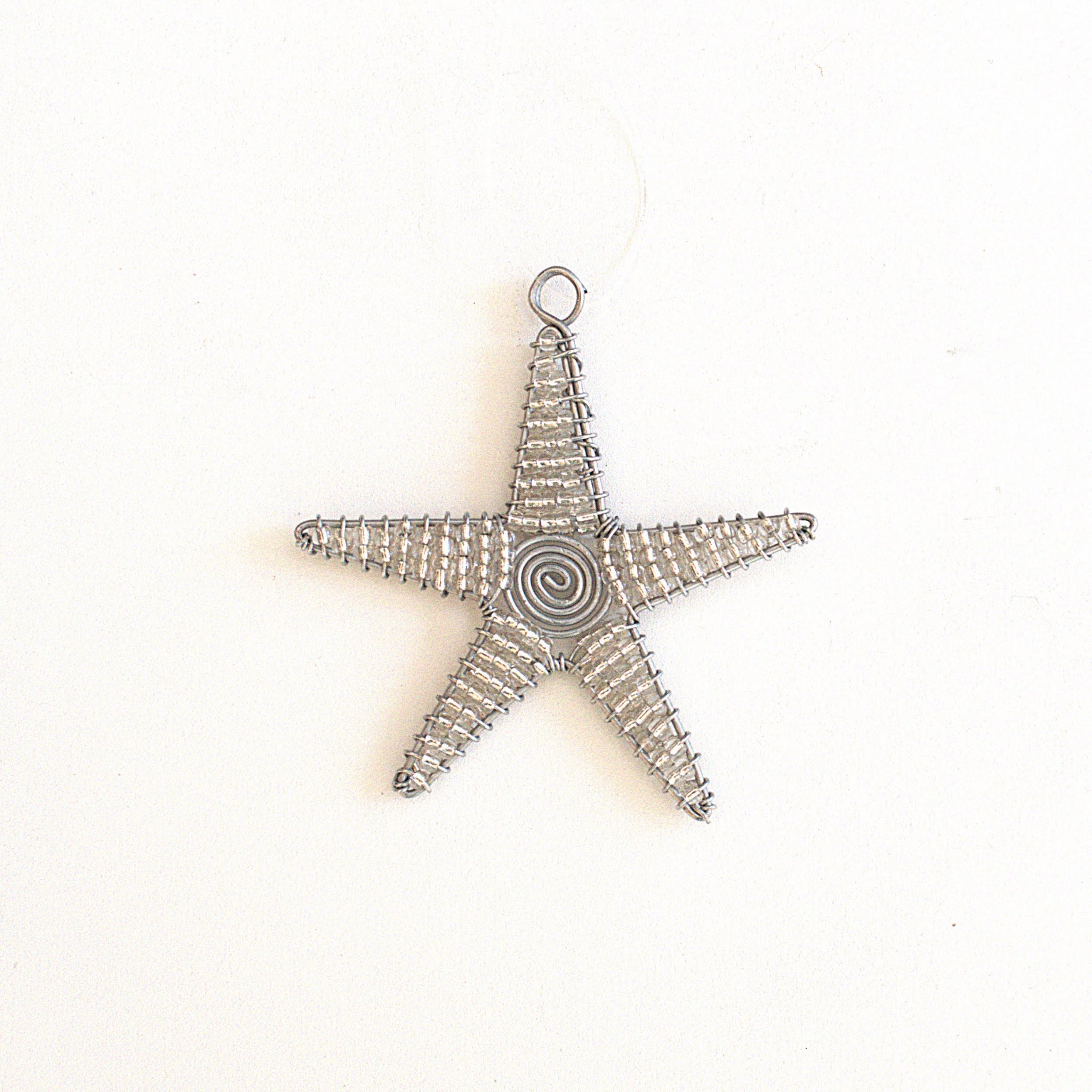 Star-shaped decorative item with a spiral design on a white background