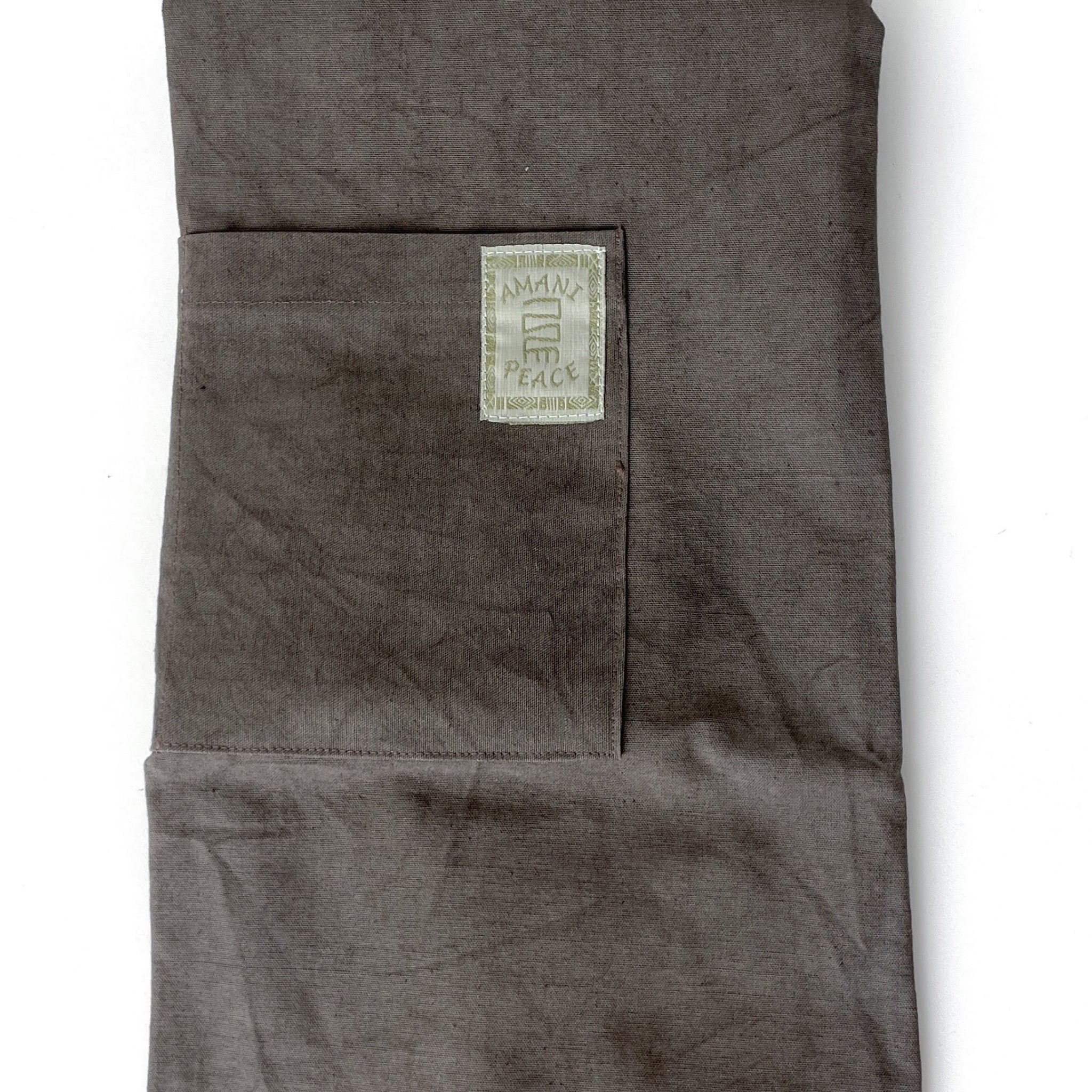 Folded dark gray fabric apron with a visible brand label on a white background