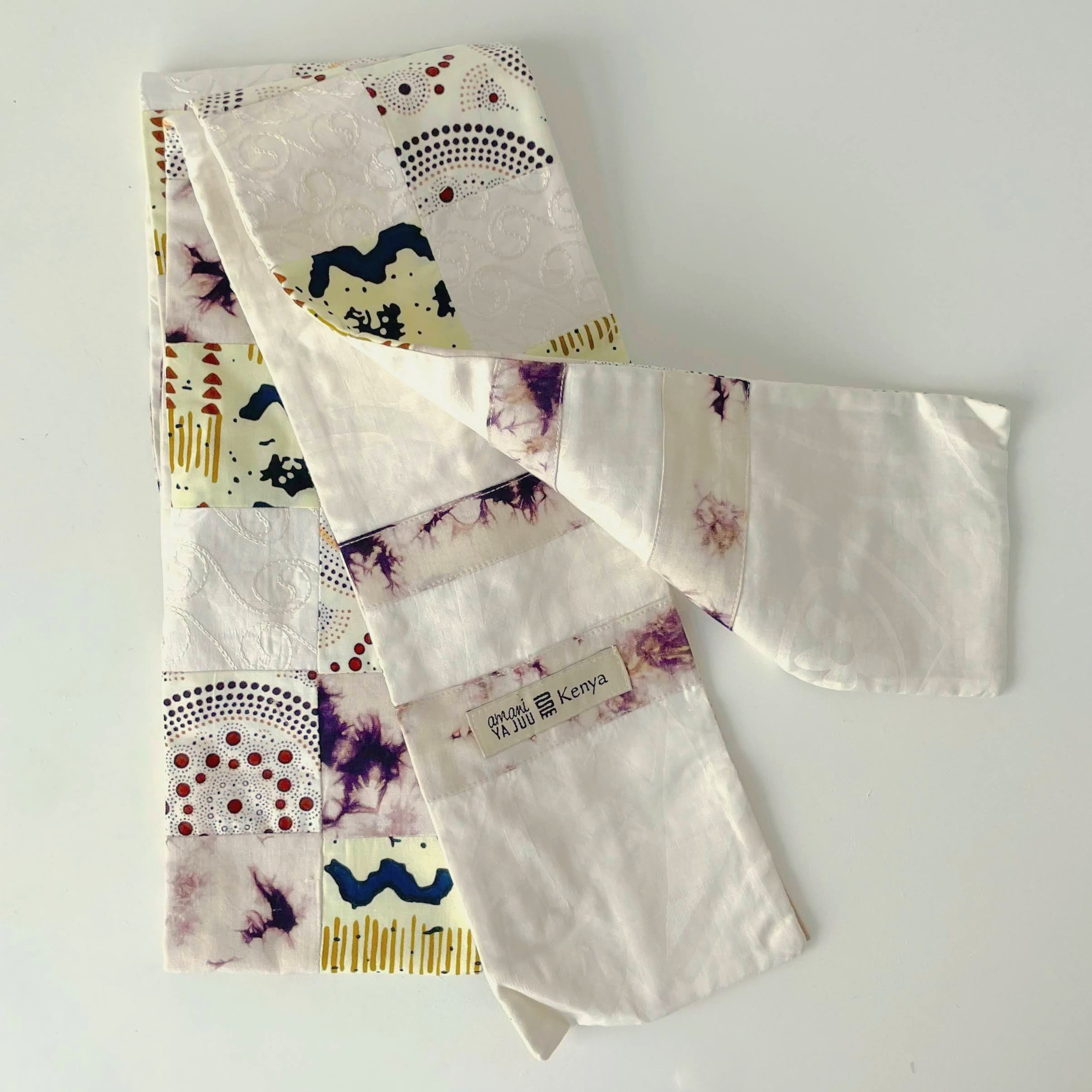 Fabric deacon stole with various patterns and a visible brand label on a white background