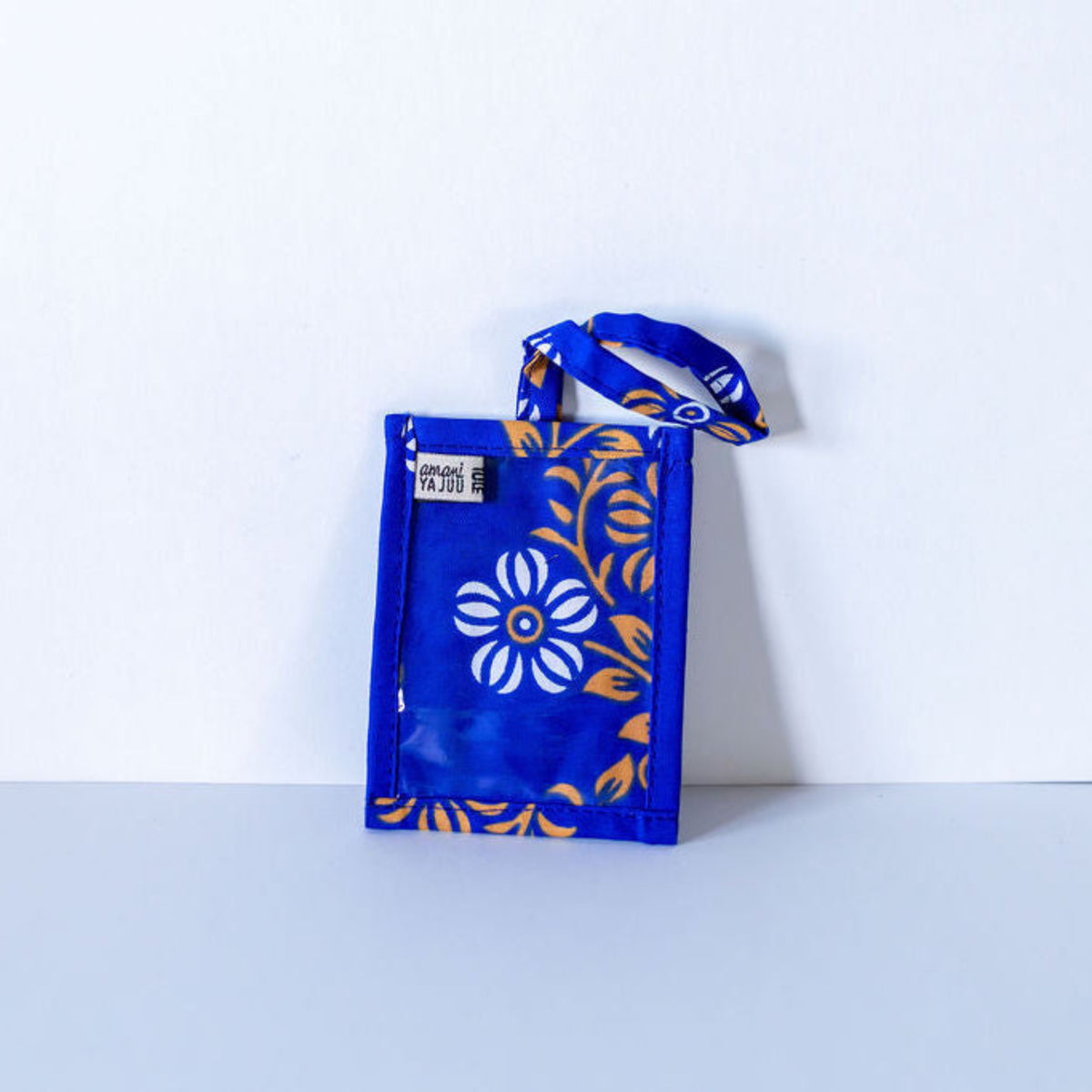 Blue and yellow fabric luggage tag on a gray background