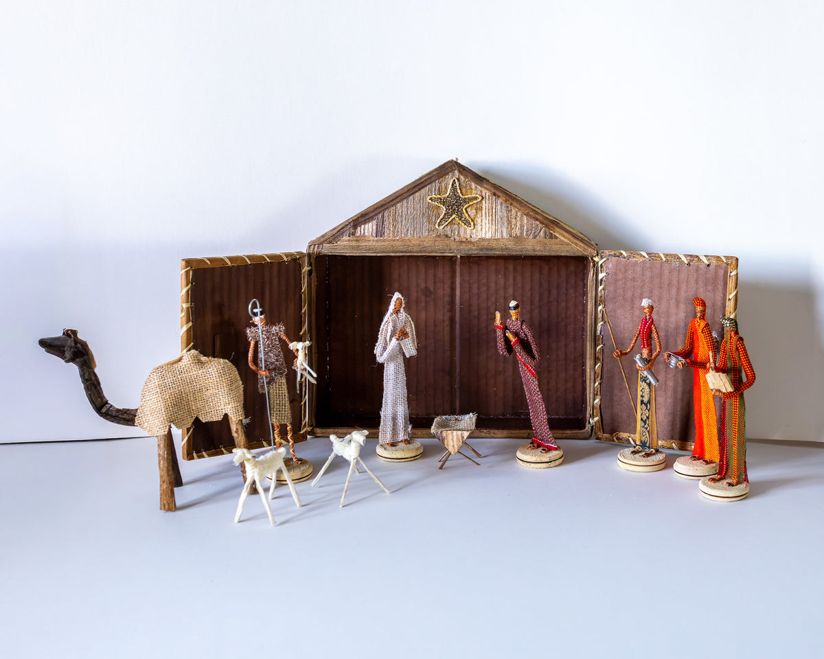 Handmade nativity set made of dried banana leaves, depicting a nativity scene with multiple figures including baby Jesus, Joseph, Mary, and various shepherds and animals