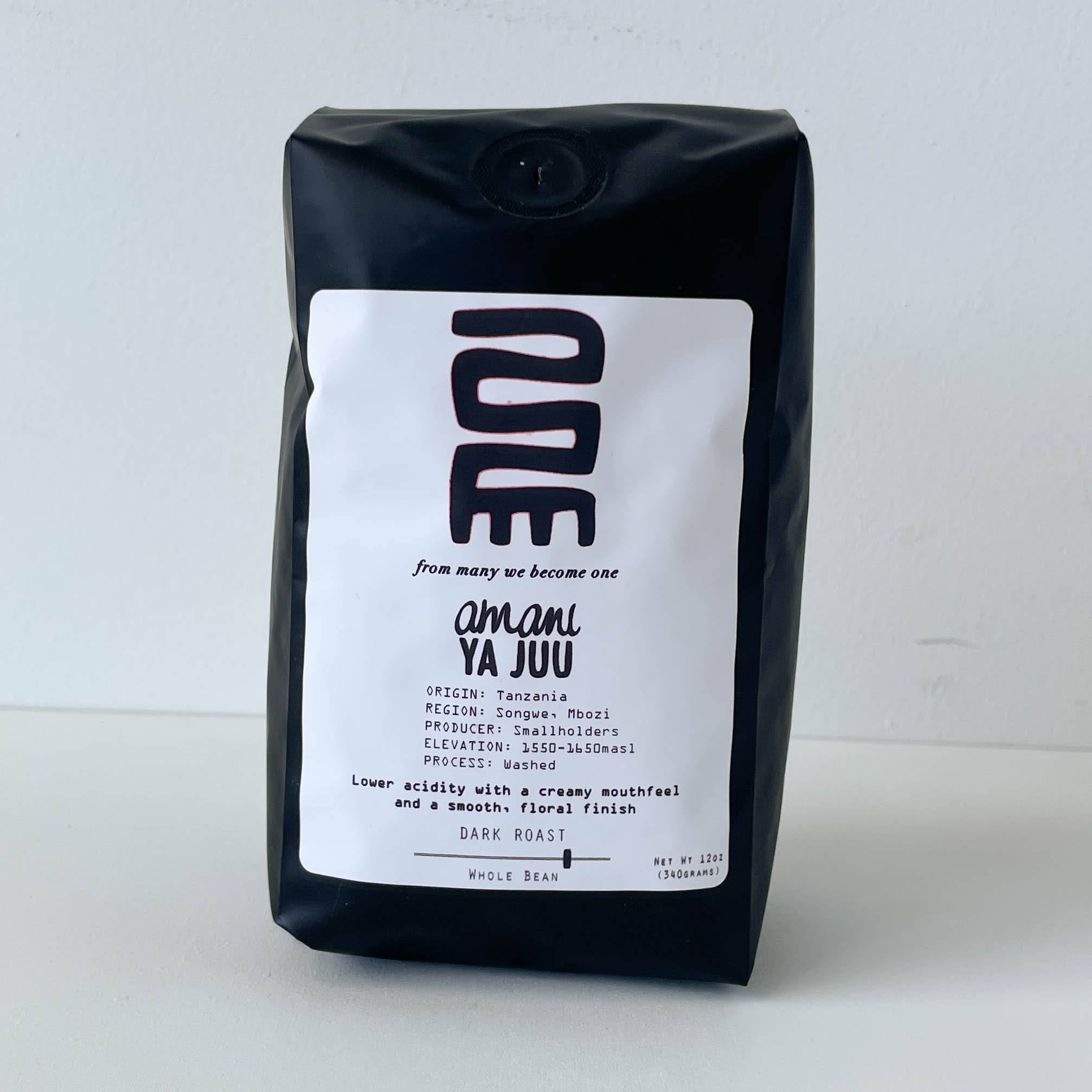 Black coffee bag with white label on a light gray background