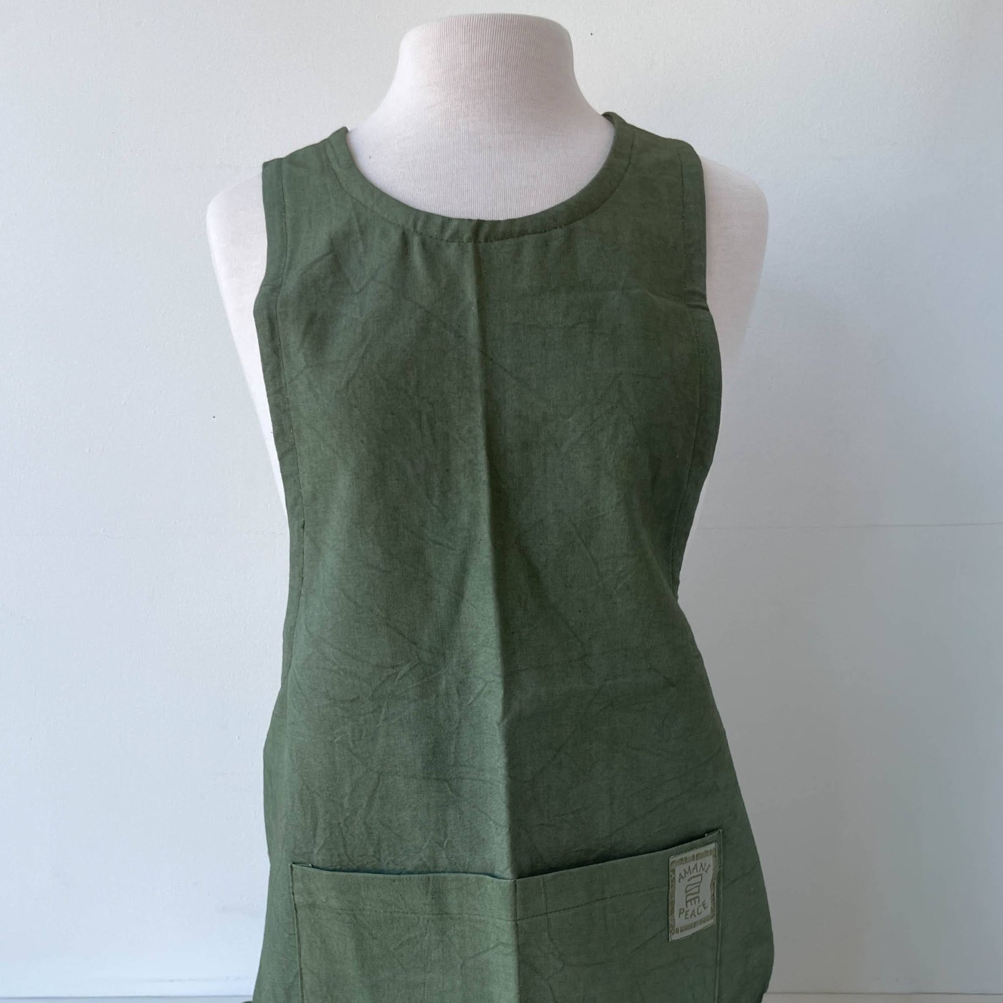 Green apron on a mannequin against a white background