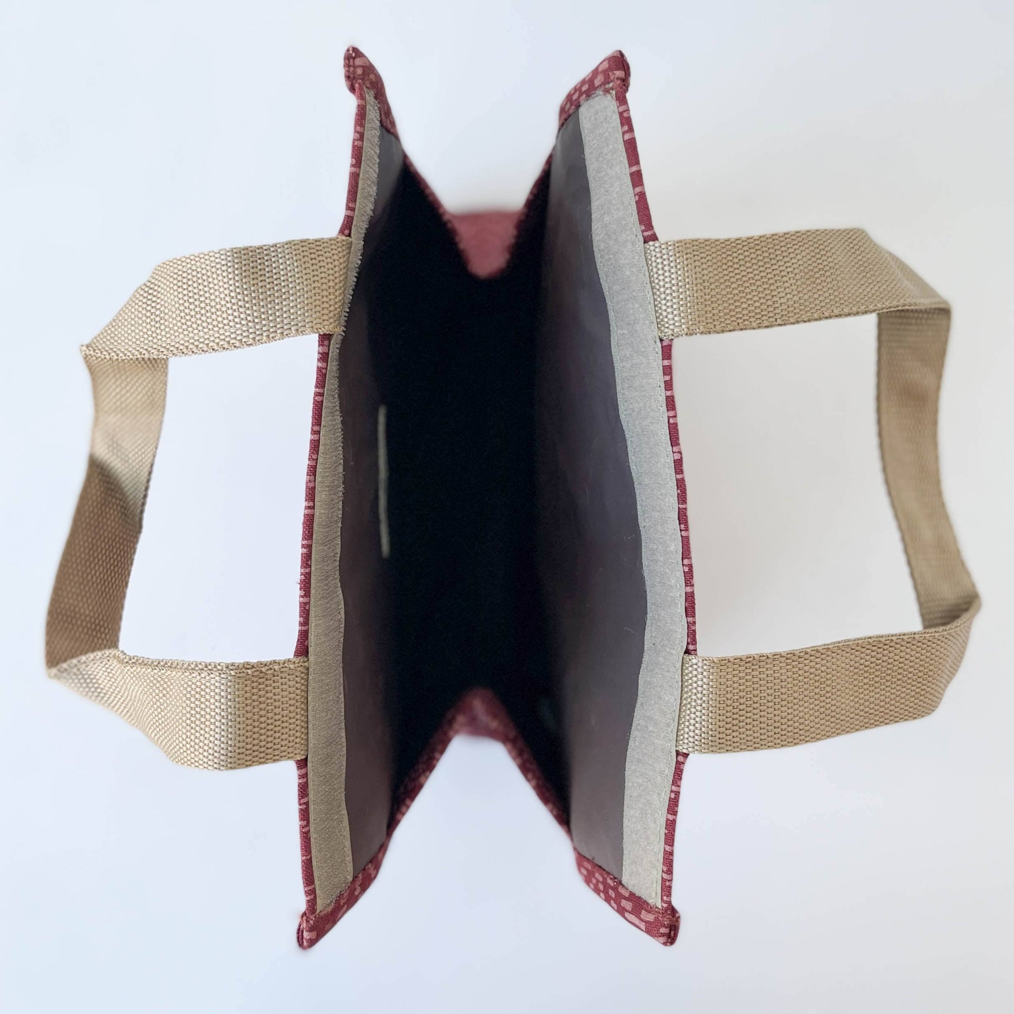 Fabric-covered product with beige and red trim on a white background