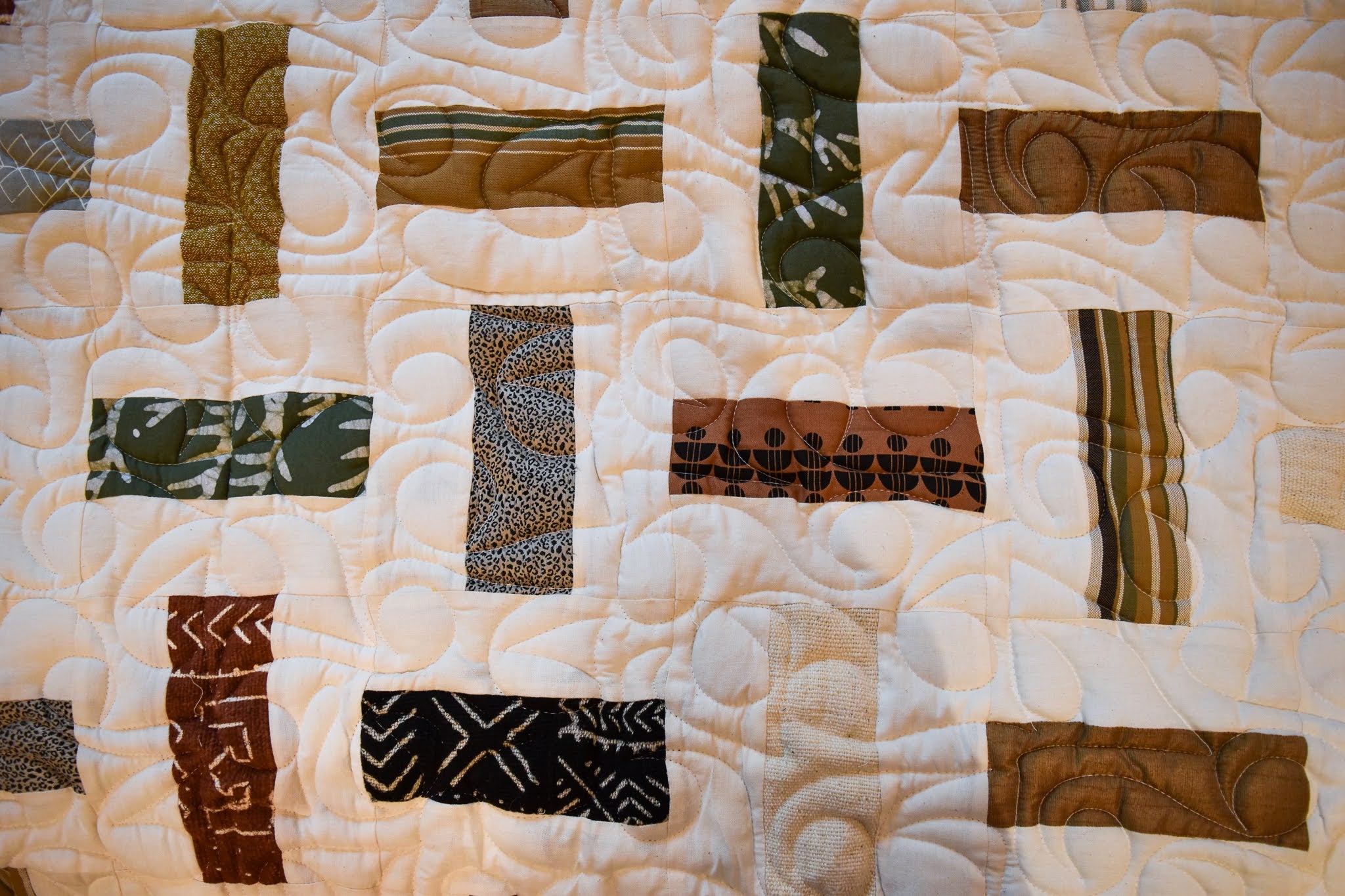 A handmade Kenyan quilt - cotton cloth hand stitched together by the Amani women for a Fair Trade boutique