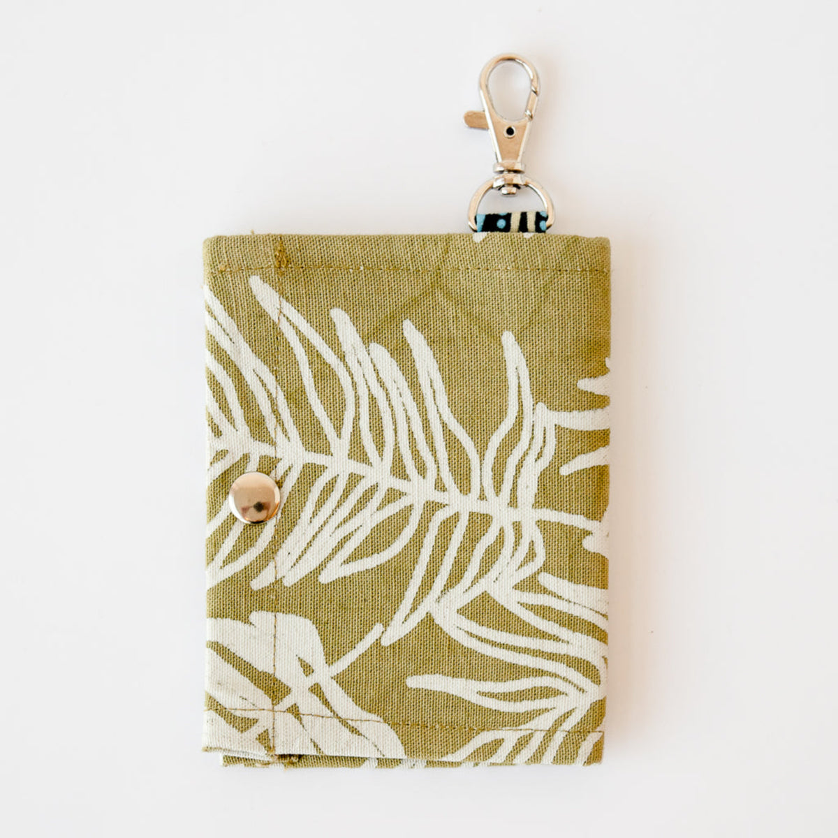 Moss green ID wallet with fern pattern and silver clasp on white background