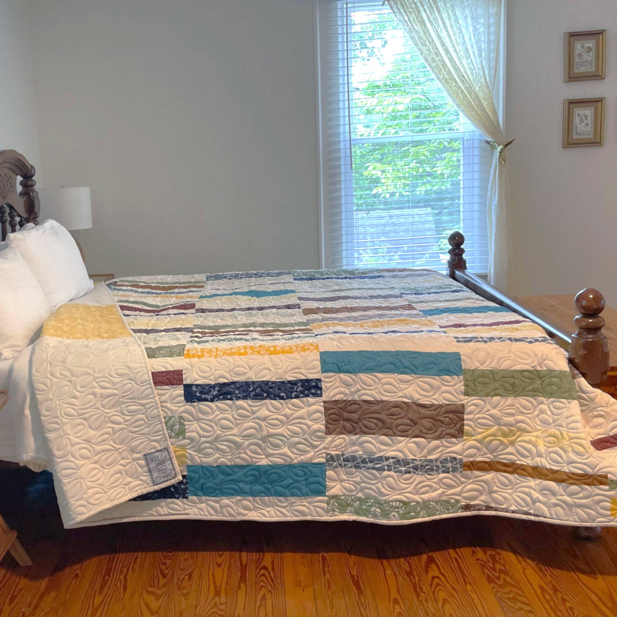 Bed with a colorful quilt in a bedroom setting