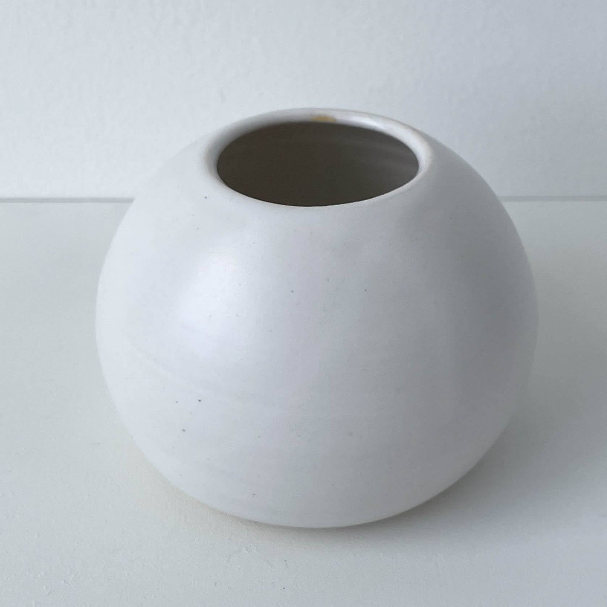 White spherical vase on a white background