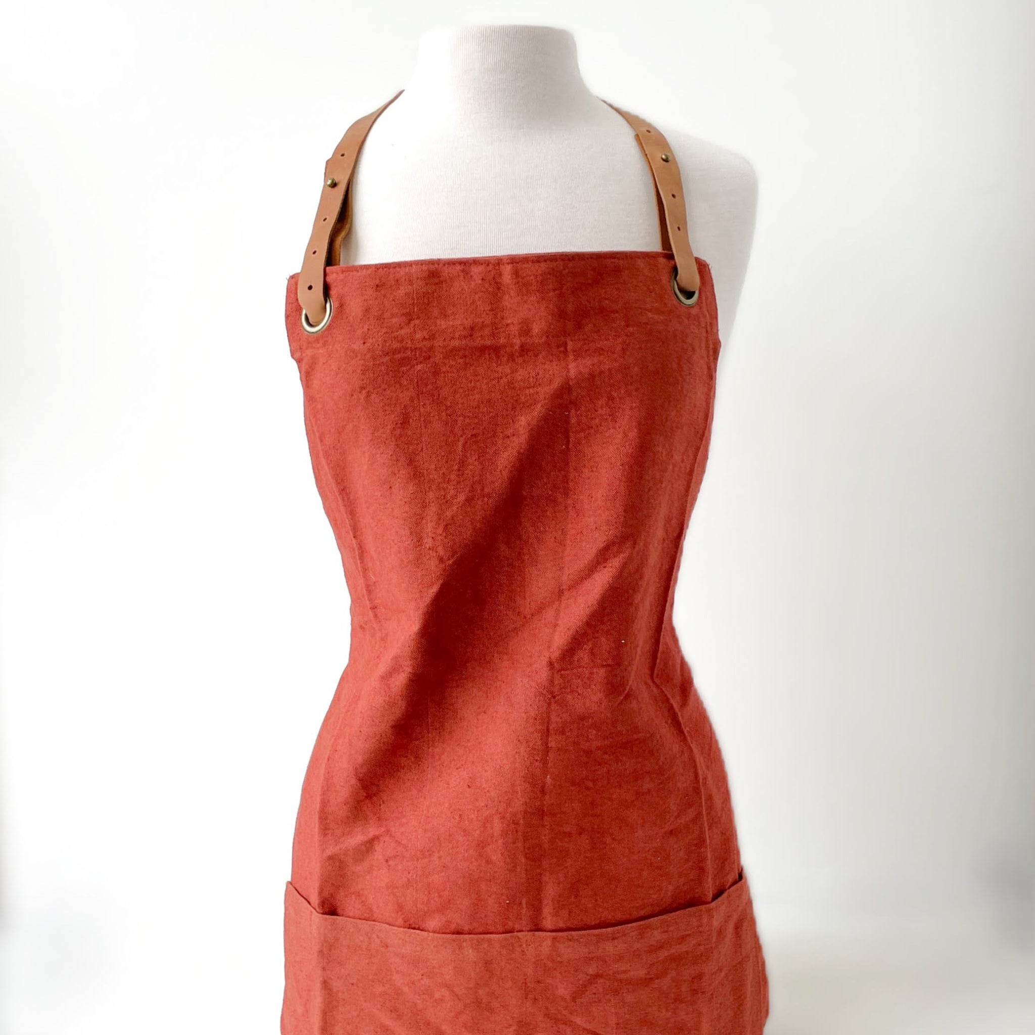 Red apron on a mannequin against a white background
