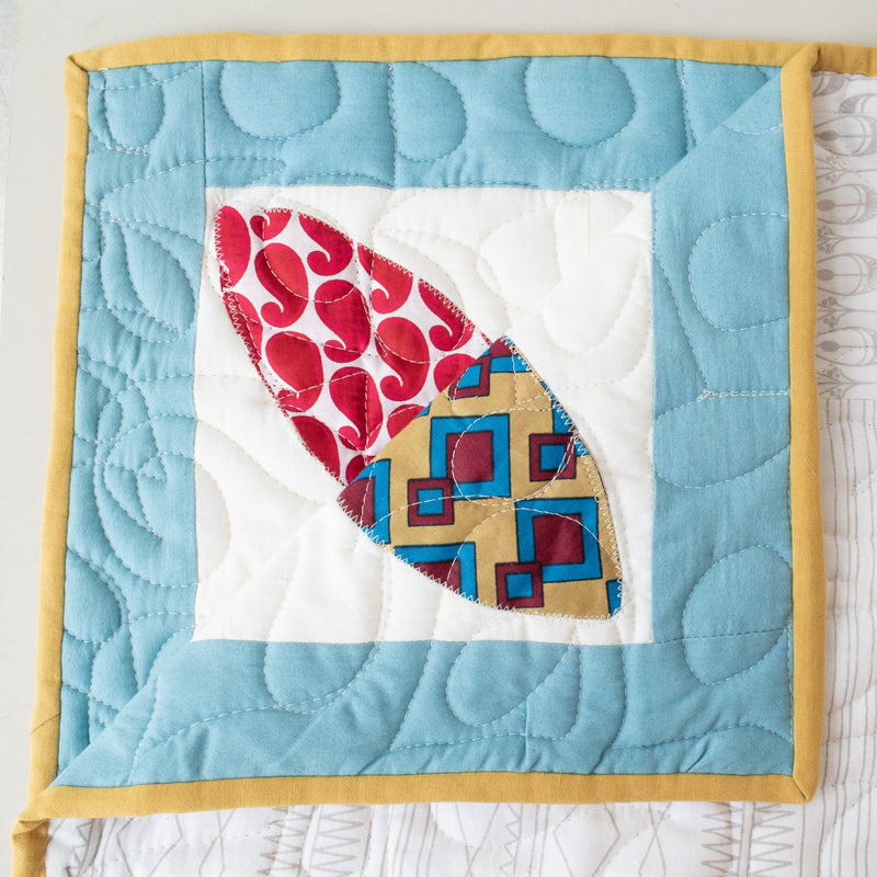 Hand stitched, hand dyed fabrics pieced together for an Amani ya Juu baby quilt