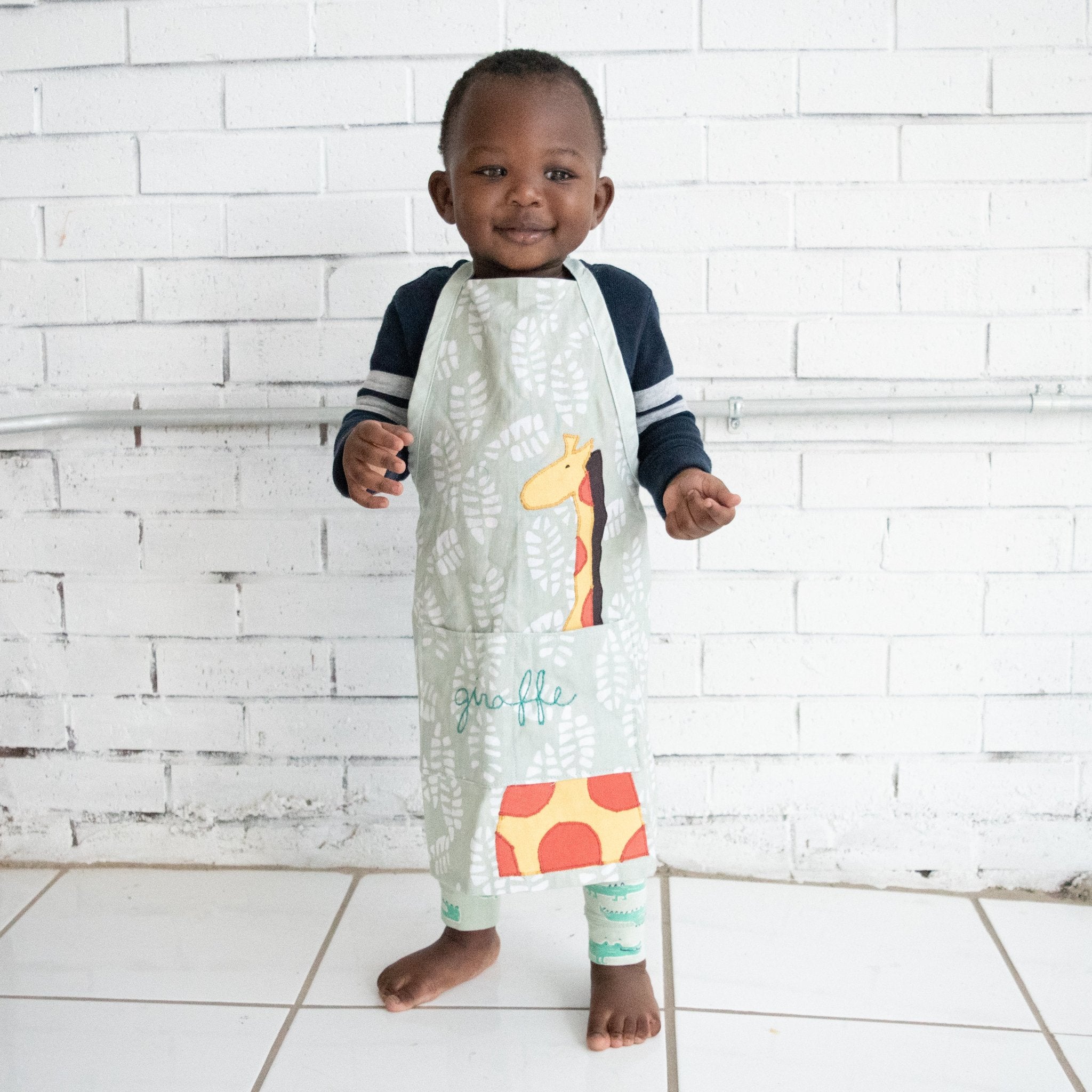 Watoto play apron - Original batik design handmade by the women of Amani ya Juu a Fair Trade member