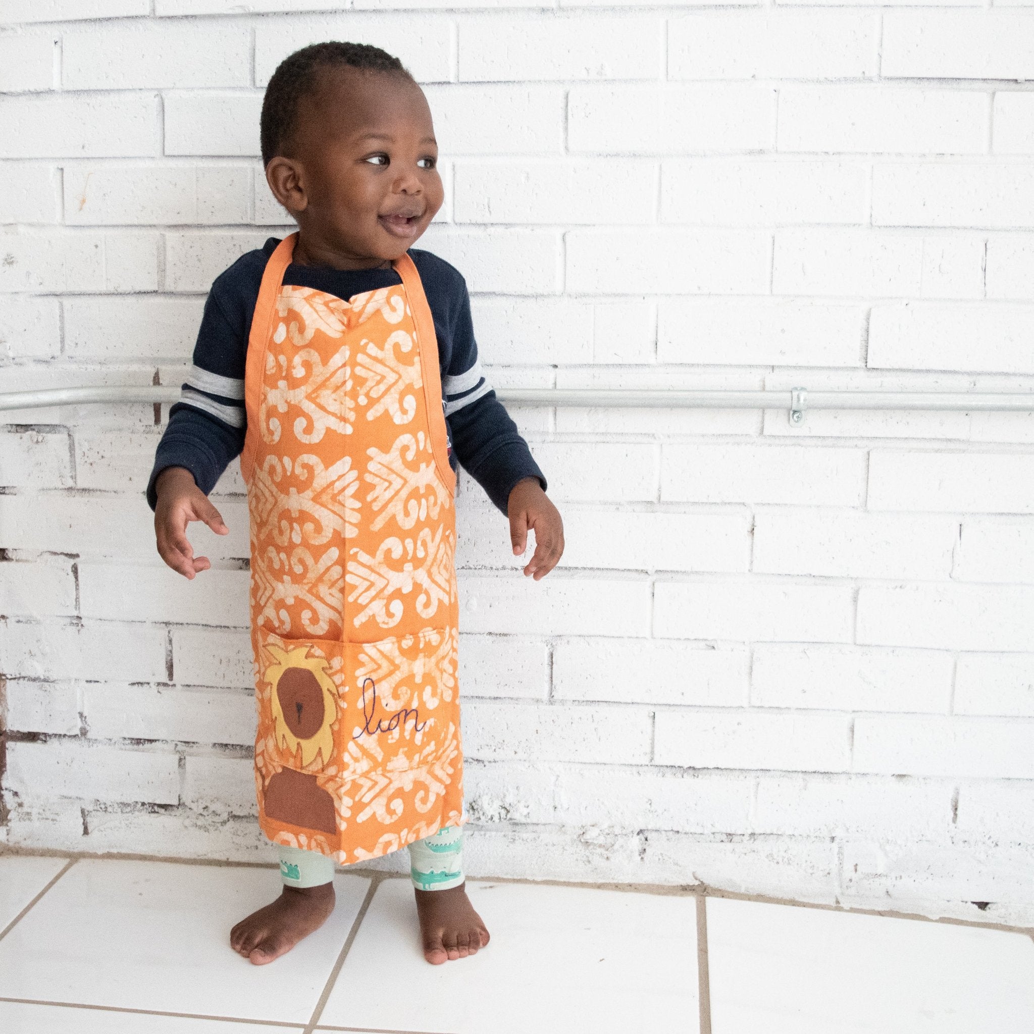 Watoto play apron - Original batik design handmade by the women of Amani ya Juu a Fair Trade member