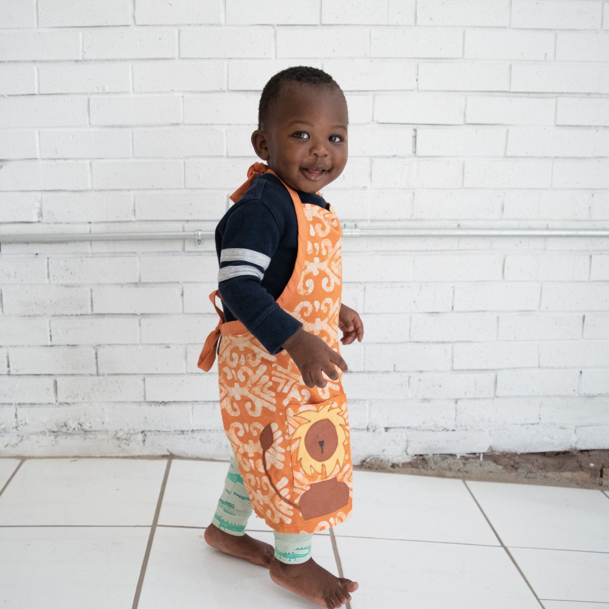 Watoto play apron - Original batik design handmade by the women of Amani ya Juu a Fair Trade member