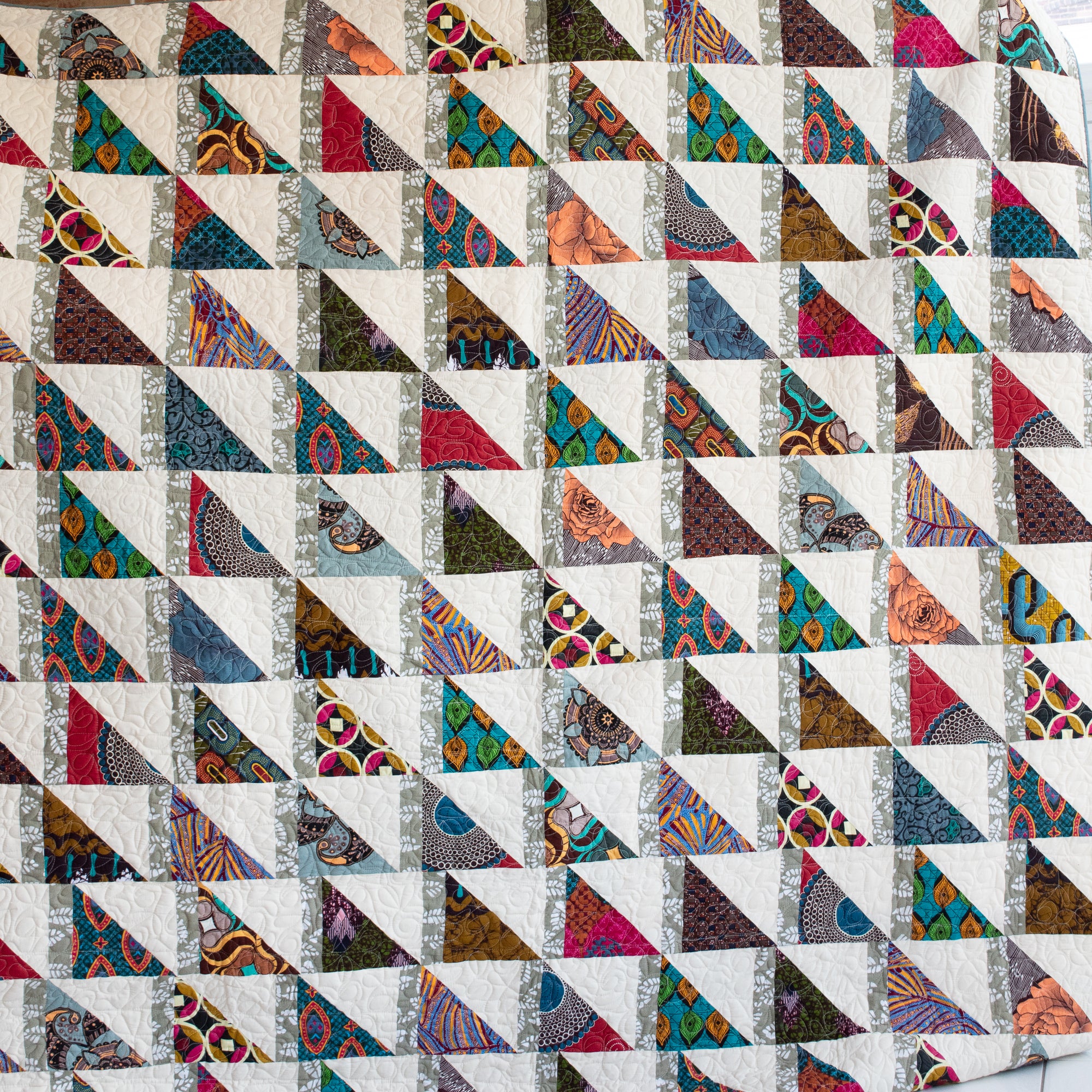 Colorful Kitenge pieces hand stitched together to make an Amani ya Juu quilt