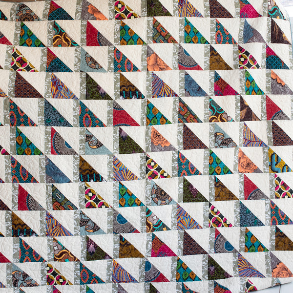 Colorful Kitenge pieces hand stitched together to make an Amani ya Juu quilt