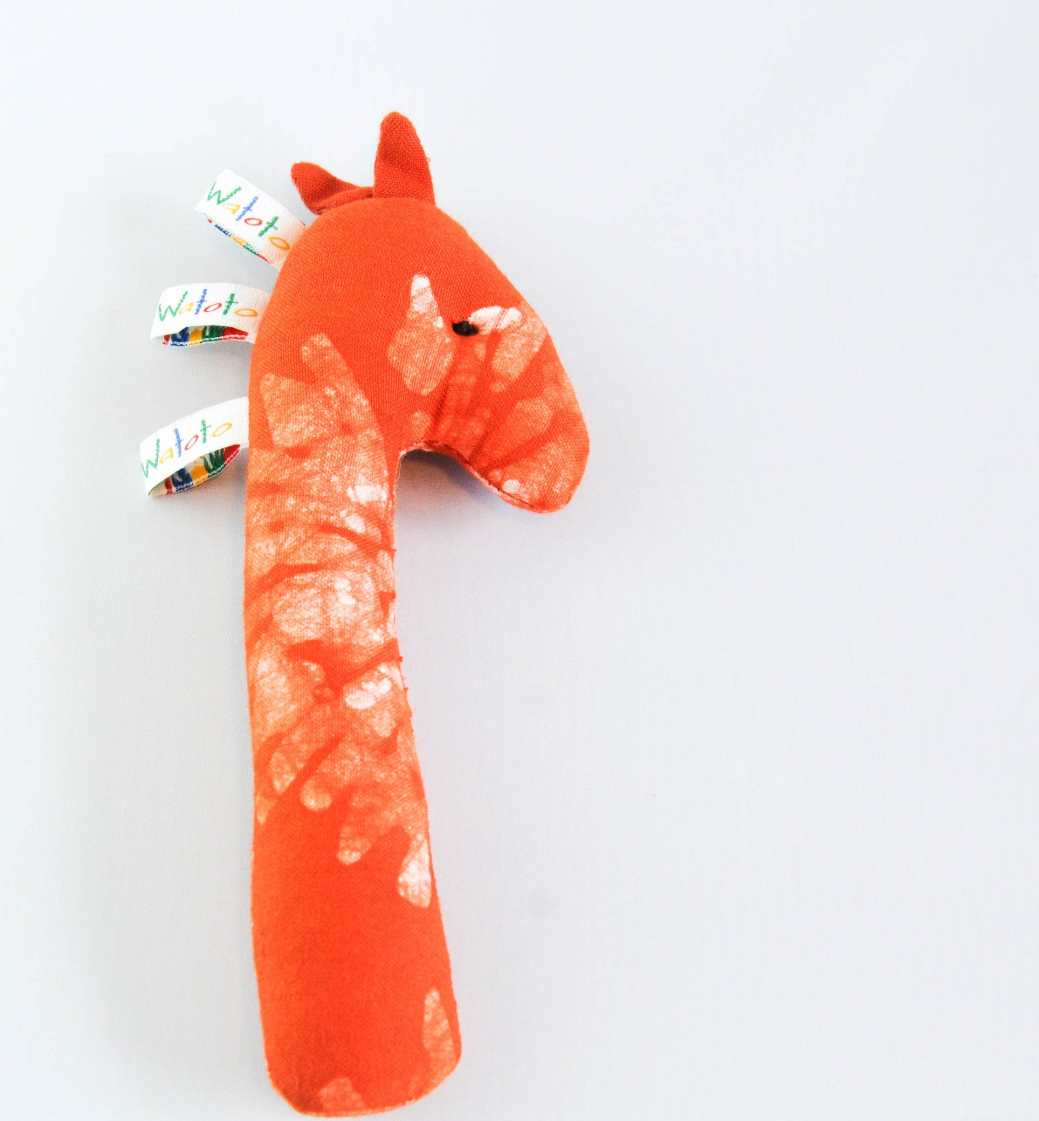 orange giraffe baby rattle on white background