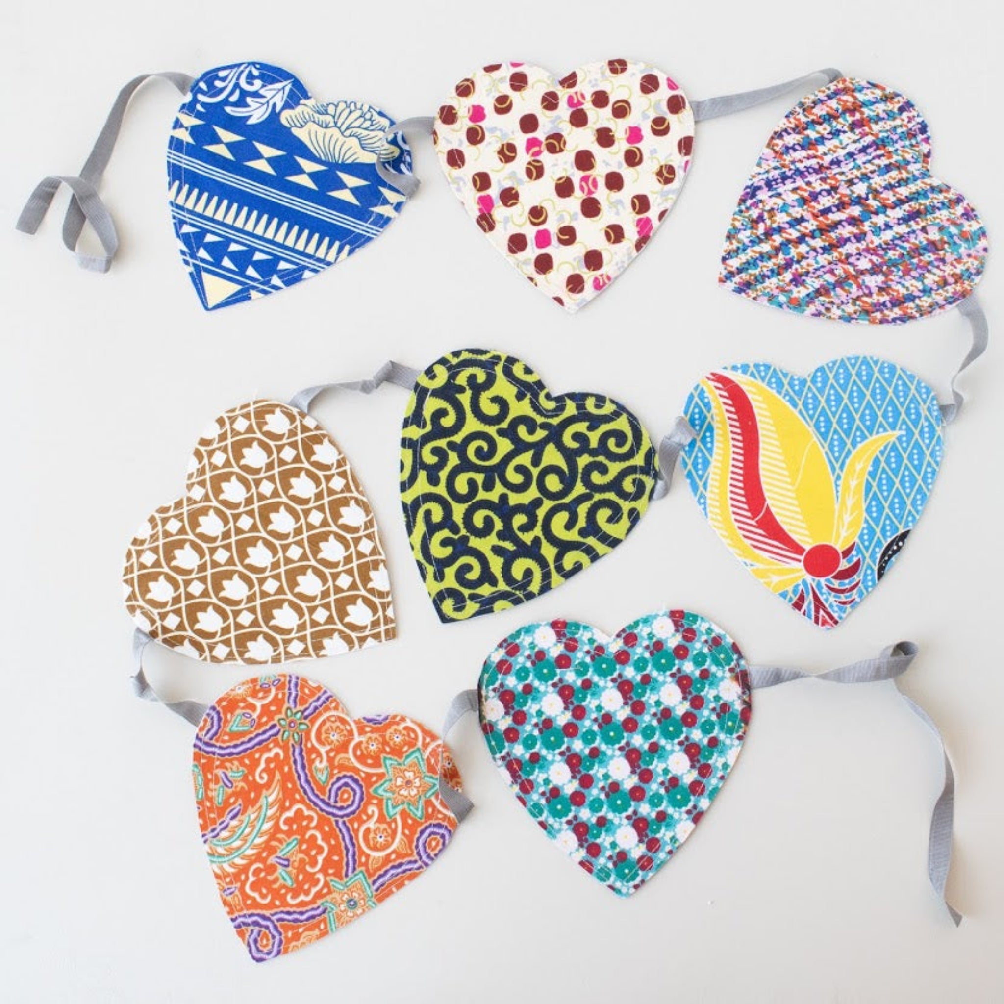 Garland of heart-shaped fabric with various patterns on a white background