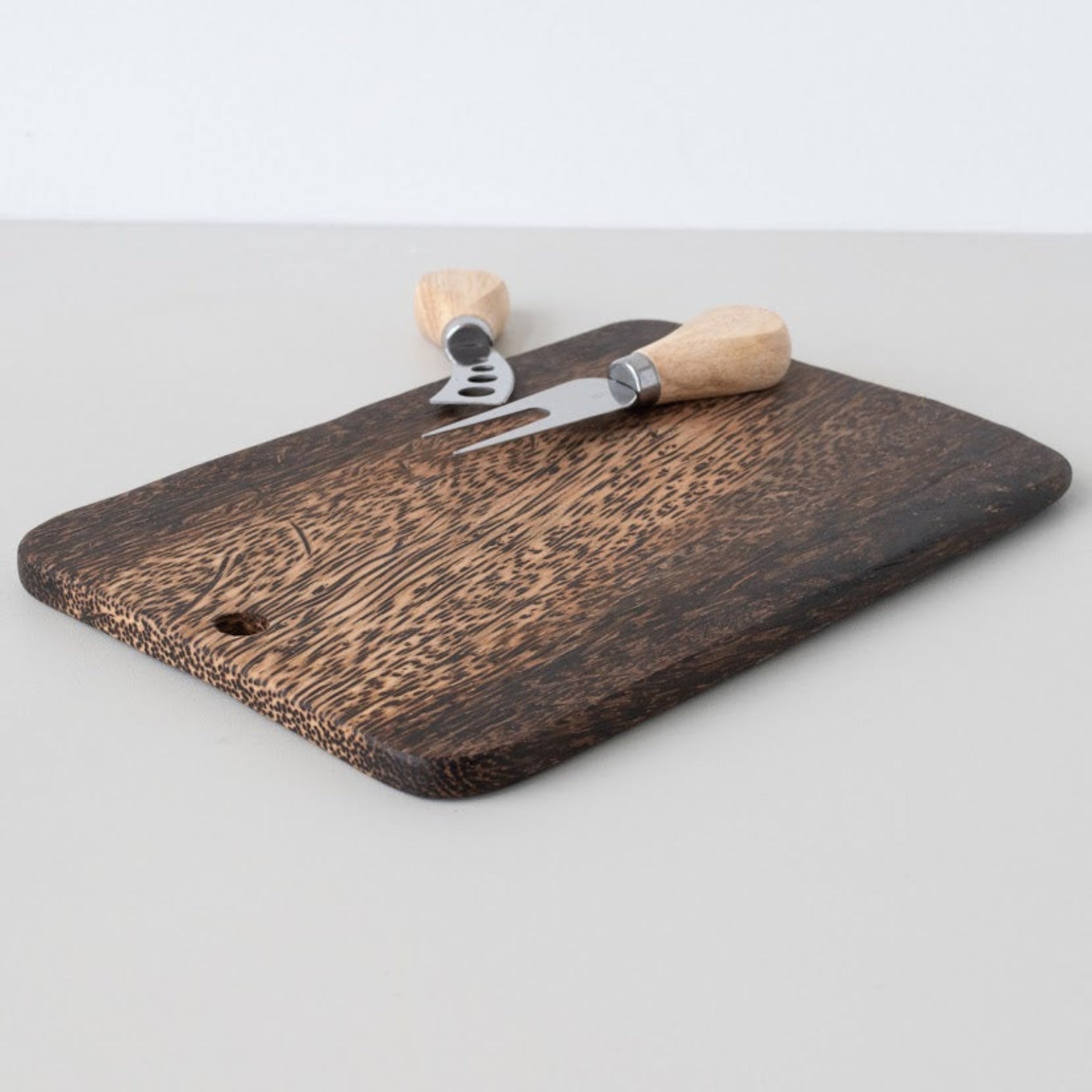 Palm Wood Cutting Board with cheese servers on a white background.