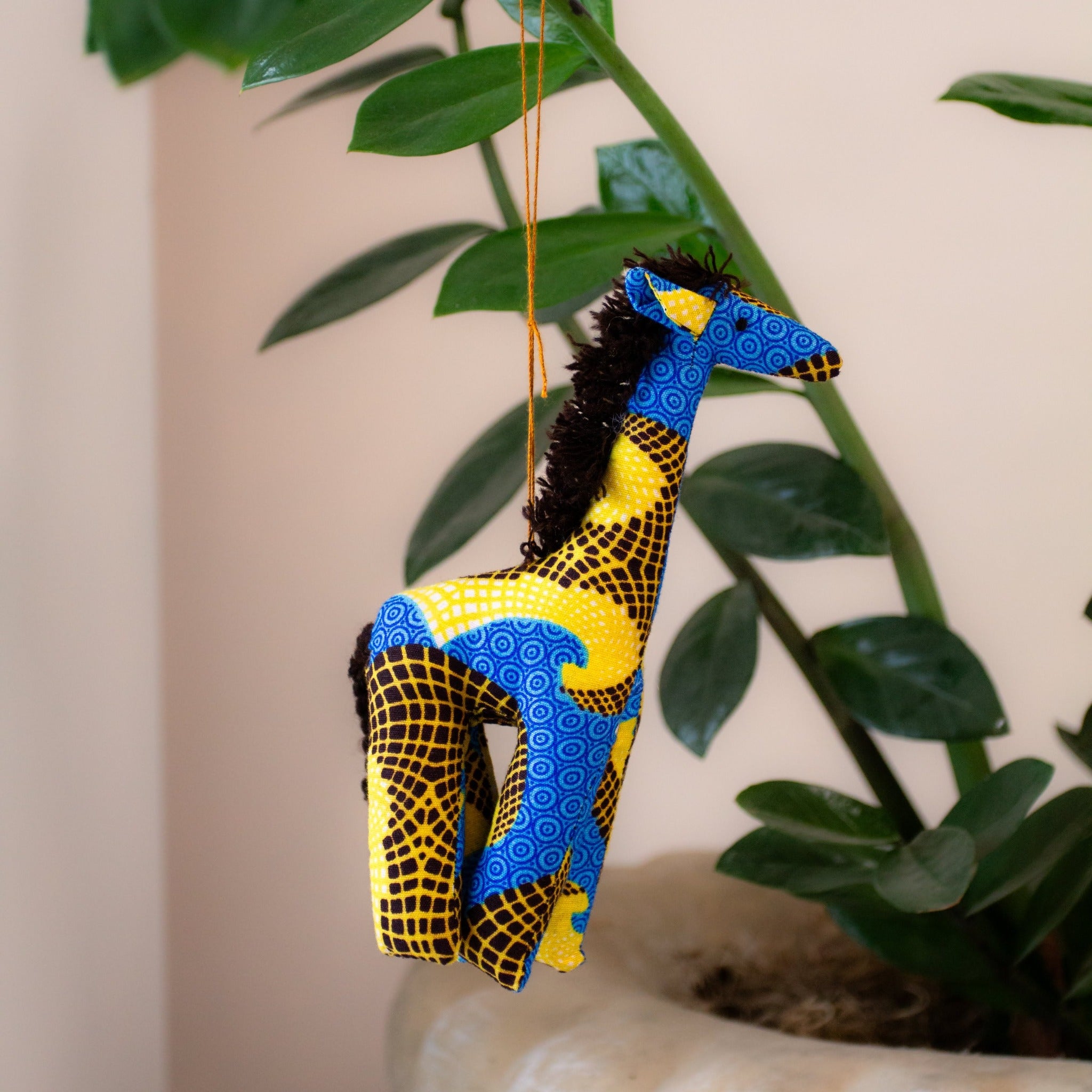 Stuffed giraffe ornament hanging on a tree